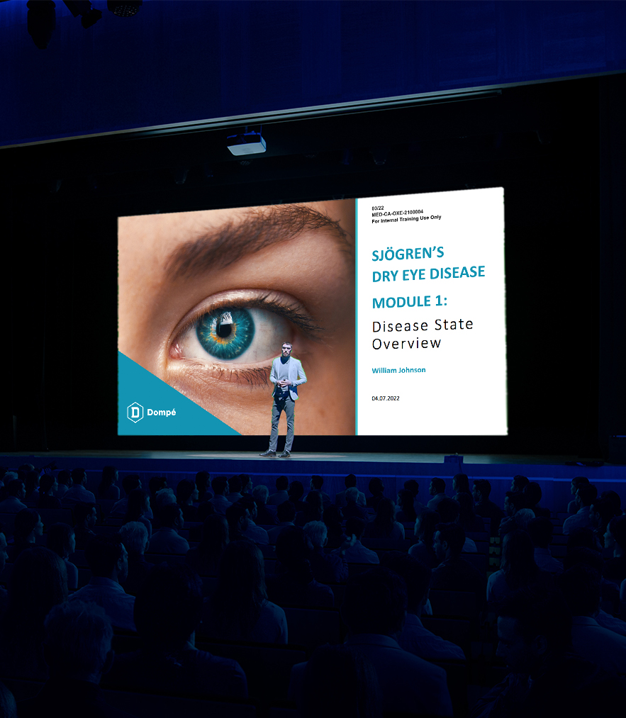 an image of a man standing on stage in front of a screen showing the cover for a presentation titled 'sjogren's dry eye disease'